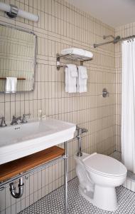 a bathroom with a sink and a toilet at Sound View Greenport in Greenport