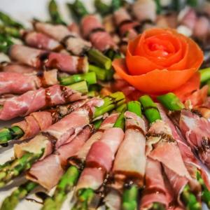 a plate of food with meat and asparagus at Inn On Fifth in Naples