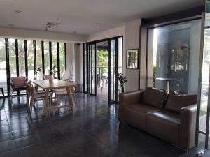 a living room with a couch and a table at Manita Boutique Hotel in Pattaya South