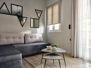 a living room with a couch and a table at Pothos Suites in Zakynthos Town