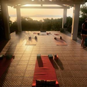 a group of yoga mats on a patio at Hotel Paola in Carloforte