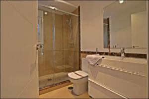 a bathroom with a toilet and a glass shower at CASA VIRIATO in Ayamonte +19 photos