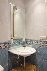 a bathroom with a sink and a mirror at Rosa Street Apartment in Girona +9 photos
