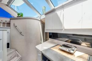 a kitchen with white cabinets and a stove at Infinity Yacht in Downtown St Augustine in Saint Augustine