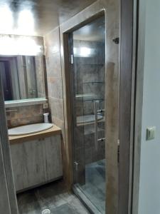 a bathroom with a shower and a sink at Utsi in Liyidhés +12 photos