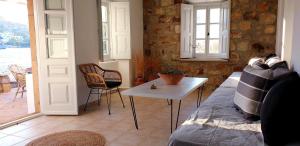a living room with a couch and a table at Villa Εν Πλω (Enplo) in Grikos +37 photos