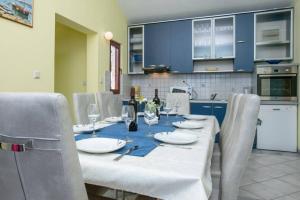 a table with wine bottles and glasses on it in a kitchen at Villa Cerjan - Sevid in Sevid