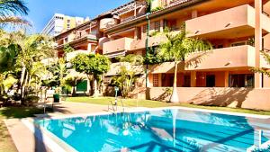 a swimming pool in front of a building at MARBELLA ALICATE BEACHFRONT - Luxury Apartment-1 in Marbella