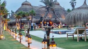 a resort with a swimming pool and a resort with umbrellas at MARBELLA ALICATE BEACHFRONT - Luxury Apartment-1 in Marbella