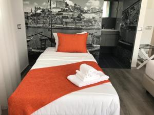 a bedroom with a bed with two towels on it at PinoyHouse Fatima in Fátima