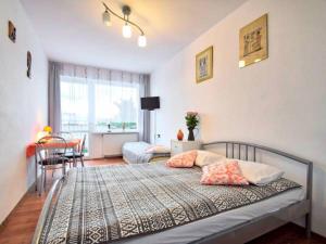 a bedroom with a bed with two pillows on it at Pokoje Malgo Ustka in Ustka