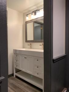 a bathroom with a white sink and a mirror at Ski in/out Spruce Glen Townhomes on Great Eastern Trail in Killington