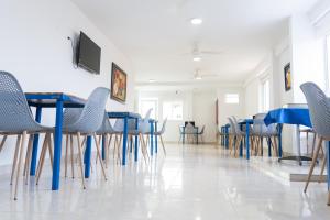 a dining room with blue tables and chairs at Hotel Aquarius in Barranquilla