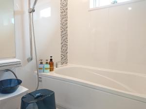 a white bath tub in a bathroom with a window at Comfort Villa V(five) in Inbu +23 photos