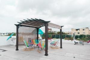 a gazebo with chairs under it on a patio at Hotel Aquarius in Barranquilla