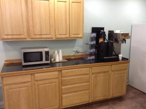 a kitchen counter with a microwave and a refrigerator at Crossroads Inn in Lebanon
