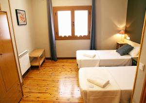 Posteľ alebo postele v izbe v ubytovaní Hostal Fonda Prat