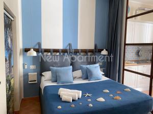 a bedroom with a blue bed with shells on it at Caprese Experience - Light Blu Apt - Dante in Naples
