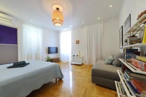 a living room with a bed and a couch at Lovely Rita's Sibenik - apartment city center in Šibenik