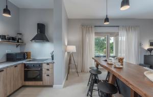 a kitchen with white walls and a counter with stools at Martinela Villas Istria - Villa Vito in Barban