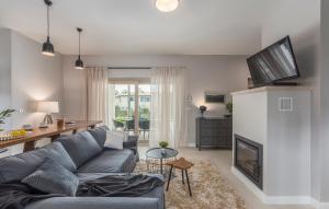 a living room with a blue couch and a fireplace at Martinela Villas Istria - Villa Vito in Barban