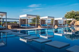 a swimming pool with lounge chairs and a swimming pool at Paralia studios in Kavos