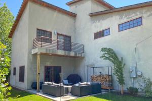 a large white house with a balcony and a patio at Custom Home Less Than 2 Mi to Downtown Boise in Boise