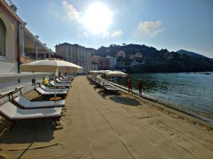 a row of chairs and umbrellas on a beach at Hotel Miramare & Spa in Sestri Levante