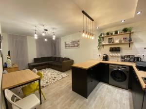 a kitchen and living room with a table and a couch at habitat Sea View Apartment Varna in Varna City