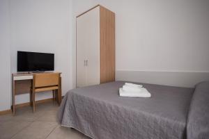 A bed or beds in a room at Hotel Amico