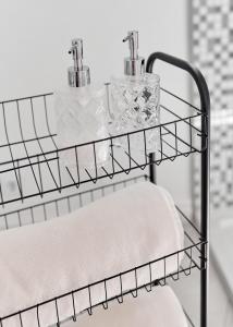 a towel rack with two towels on it in a bathroom at White Door Apartments Mansard Heart of Odessa 2 in Odesa +13 photos