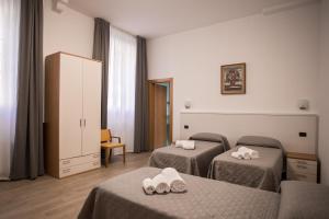 A bed or beds in a room at Hotel Amico