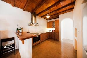 a kitchen with wooden cabinets and a wooden counter top at Villas Kappas in Agios Sostis Mykonos