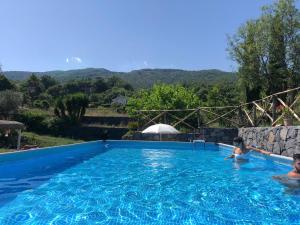 a couple of people in a swimming pool at Etnante in Zafferana Etnea