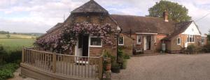 a small house with a fence in front of it at Rosemary Cottage in Hooe