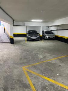 two cars are parked in a parking garage at Hotel Solar Bela Vista in São Paulo