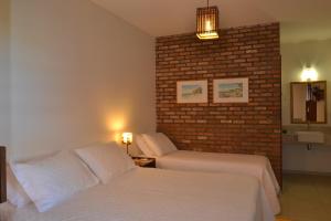 Cama ou camas em um quarto em Club do Balanço Pousada e Restaurante