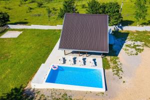 an overhead view of a swimming pool with a roof at MONA in Gračac