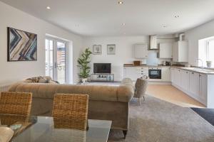 a living room with a couch and a kitchen at Host & Stay - Welton View in Whitby