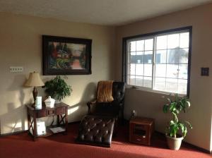 a living room with a chair and a window at DeLano Motel & RV Park Beaver in Beaver