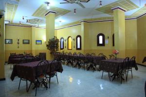a banquet hall with tables and chairs in it at Western Desert Hotel & Safari in Bawati
