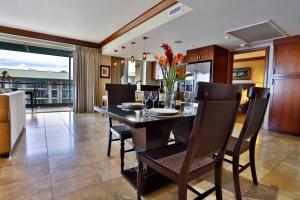 a dining room with a dining table and chairs at Honua Kai - Hokulani 709 - Best Ocean Views! 2b/2.5b in Kaanapali
