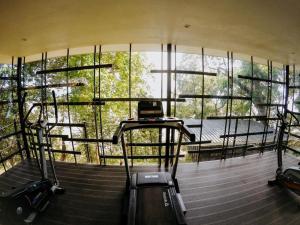 a gym with stairs and a large window at The Culvert in Kuching