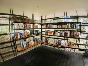 a room with shelves of books on the wall at The Culvert in Kuching