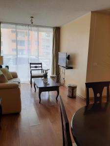 a living room with a couch and a table at Departamento Amueblado in Antofagasta