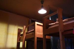 two bunk beds in a room with a light at Guesthouse MI CASA SU CASA in Zentsuji