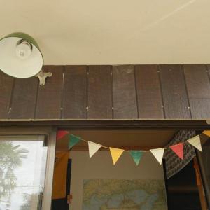 a ceiling with flags and a frisbee on it at Guesthouse MI CASA SU CASA in Zentsuji