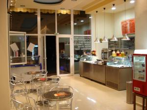 a restaurant with tables and chairs in a kitchen at Loxandra Studios in Metamorfosi