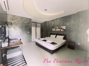 a bedroom with a bed and a desk at Pua Panorama Resort in Nan