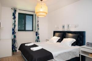 a bedroom with a large bed with two towels on it at Gorgeous Getaway (Lokrum view) in Dubrovnik